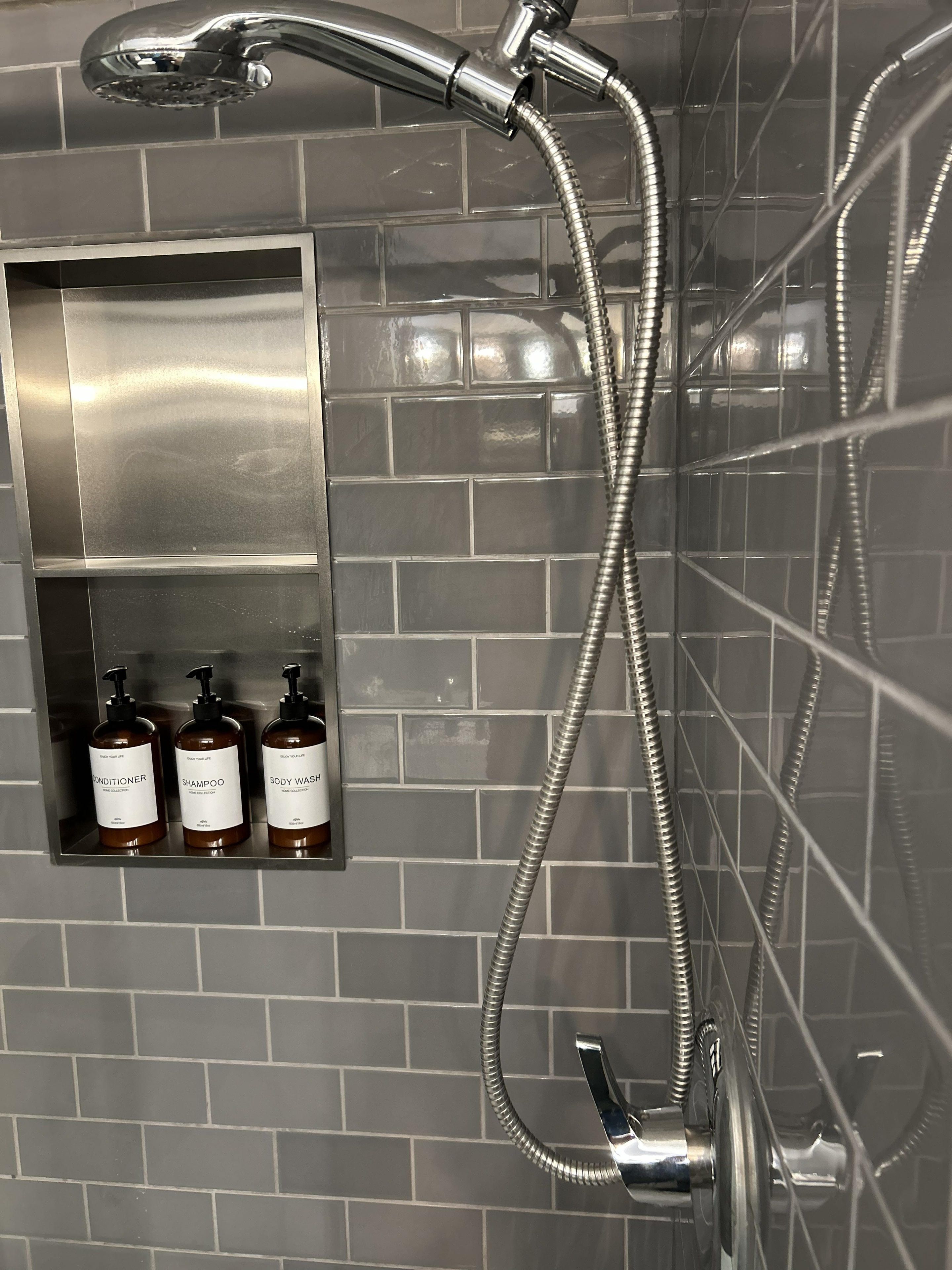 Beatrice Street suite shower with subway tile and premium toiletries